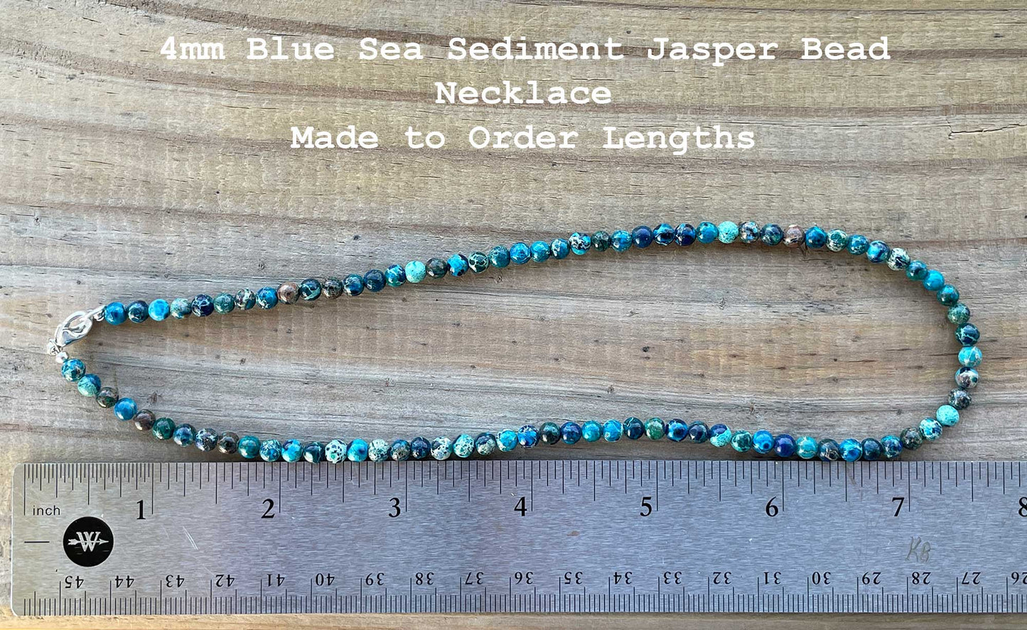 4mm Blue Sea Sediment Jasper Bead Necklace on a wooden surface with a ruler for scale.