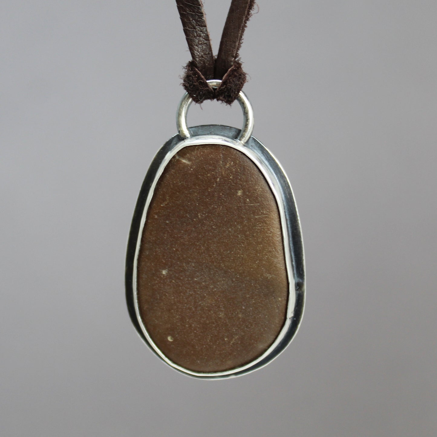 Handcrafted Brown Beach Stone Pendant in Sterling Silver with Deer Skin Lace