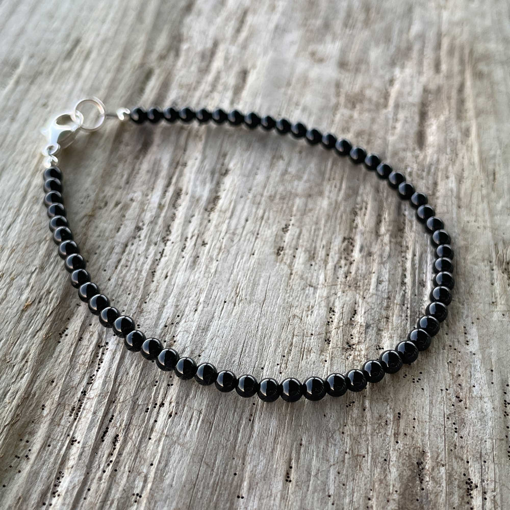 
                      
                        Dainty Black Beaded Bracelet
                      
                    