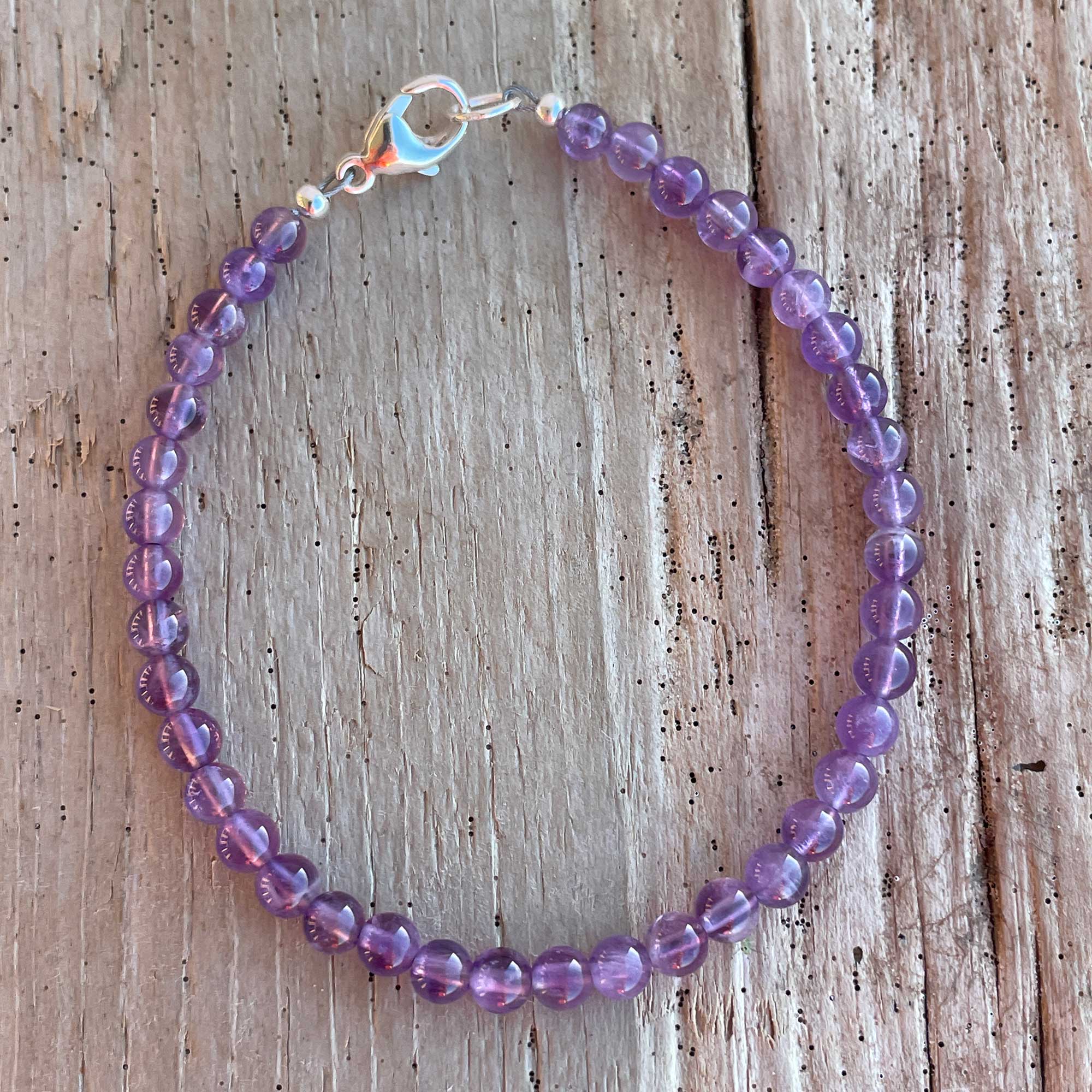 Amethyst selling beaded bracelet, with purple swarovski charm,also,Sterling beads,and St