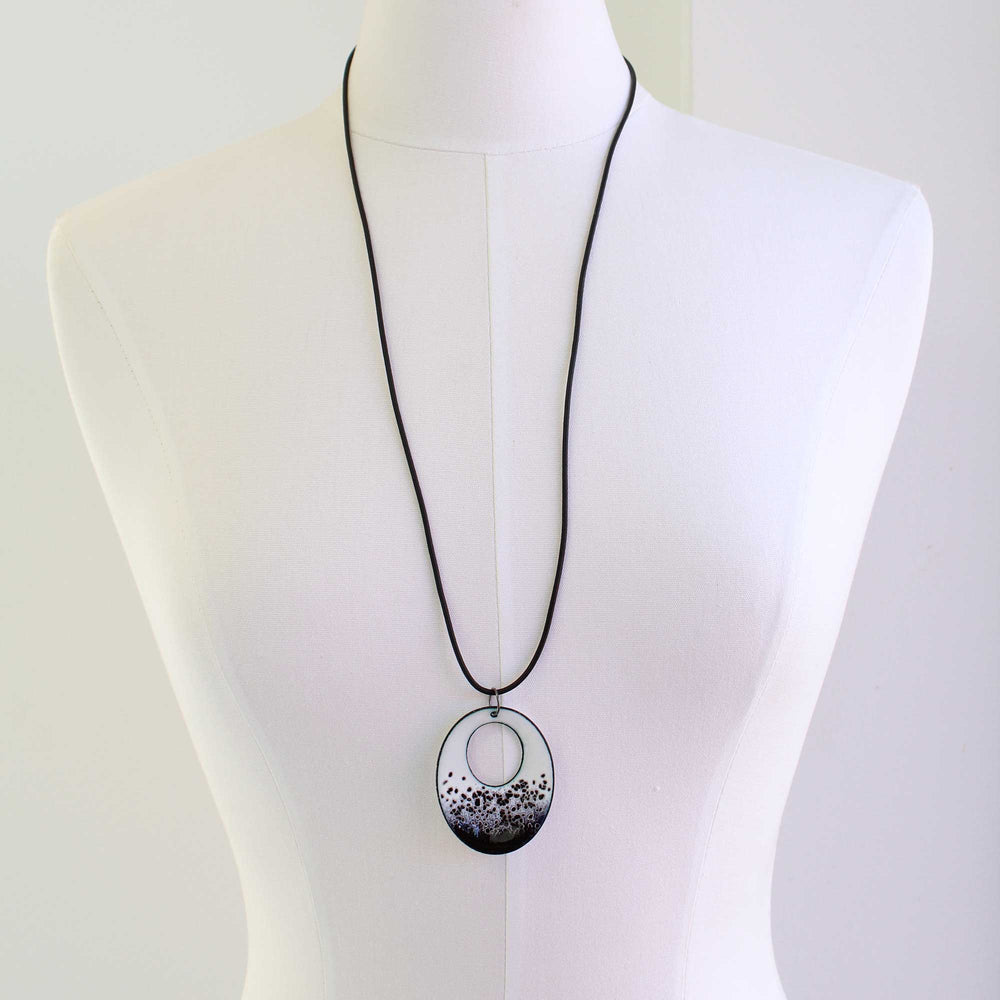 
                      
                        Long black and white pendant necklace
                      
                    