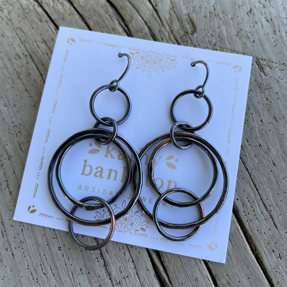 
                      
                        Copper Floating Circle Hoop Earrings with Sterling Silver Ear Wires  by Kathy Bankston
                      
                    