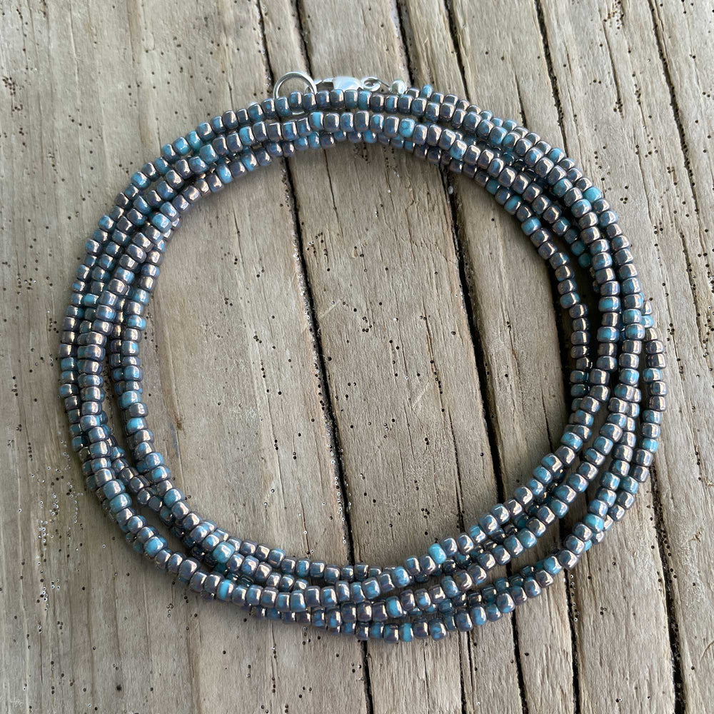 
                      
                        Gilded Marble Turquoise Seed Bead Necklace
                      
                    