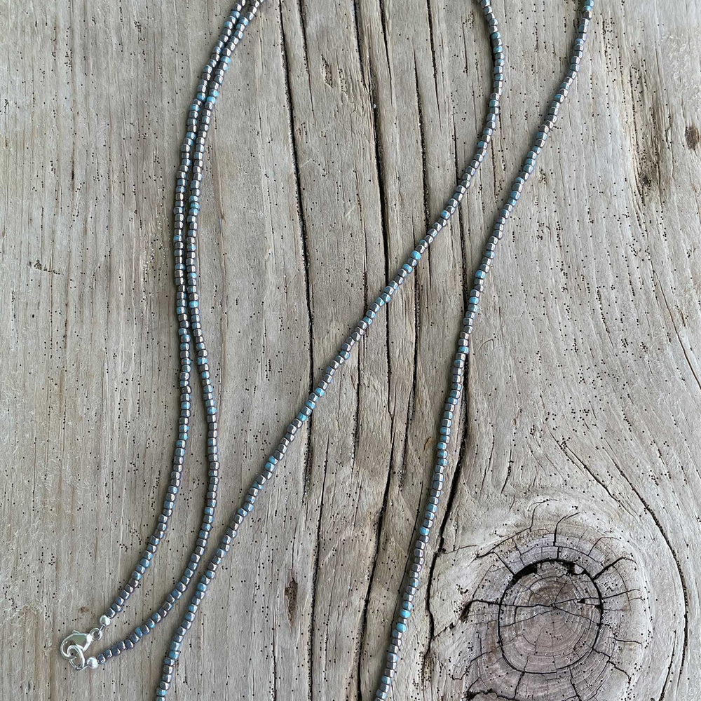 
                      
                        Gilded Marble Turquoise Seed Bead Necklace
                      
                    