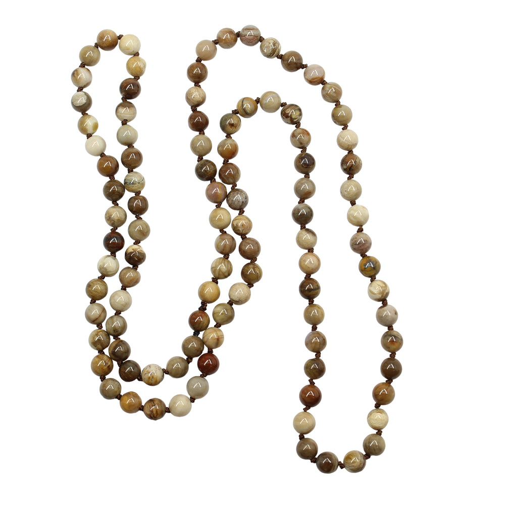 
                      
                        Long necklace with brown and beige beads on a white background
                      
                    