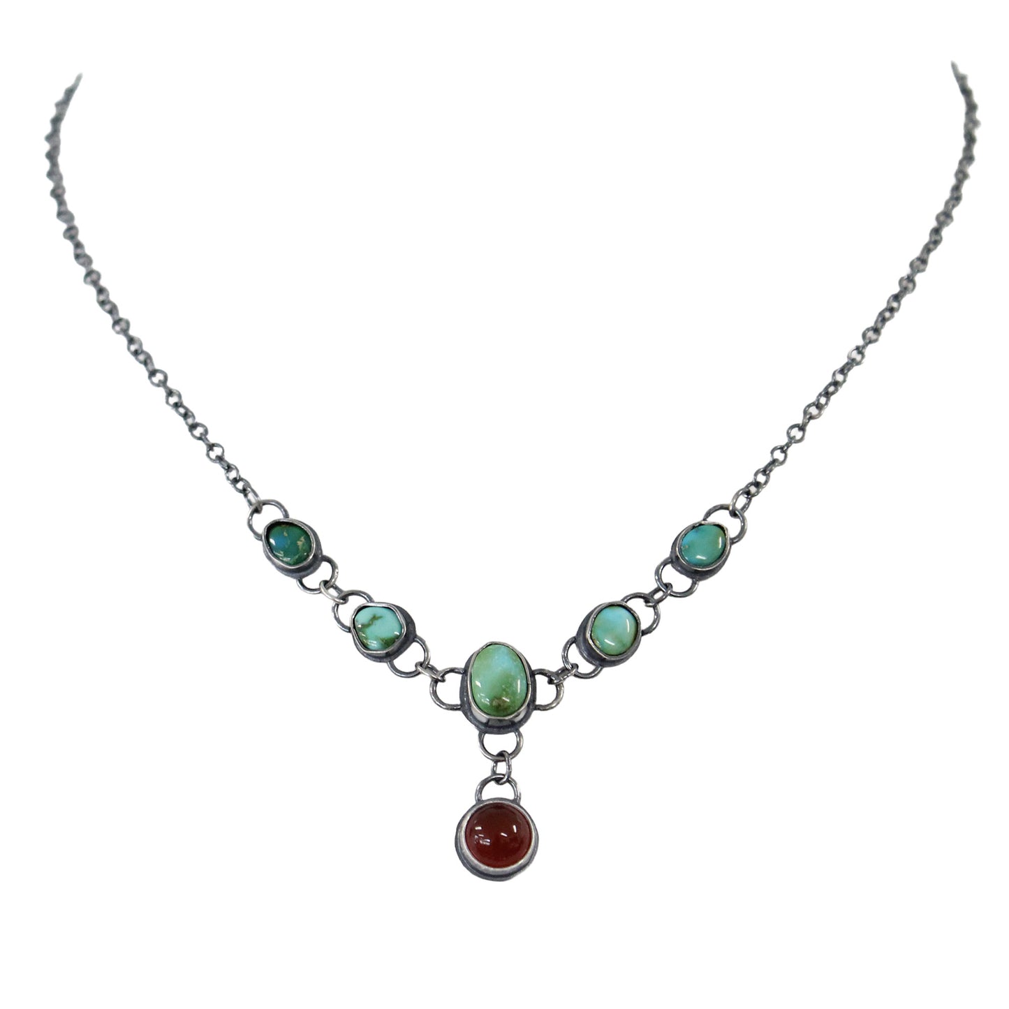 A portrait-oriented view of a dainty turquoise Y-necklace on a white background, showcasing the asymmetrical beauty of the hand-cut stones and silver craftsmanship.