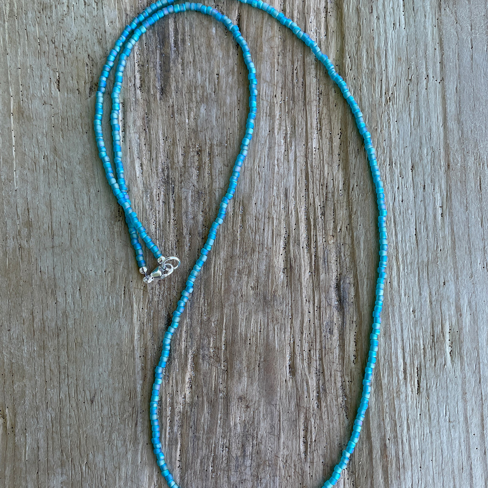 
                      
                        Matte Transparent Turquoise Seed Bead Necklace
                      
                    