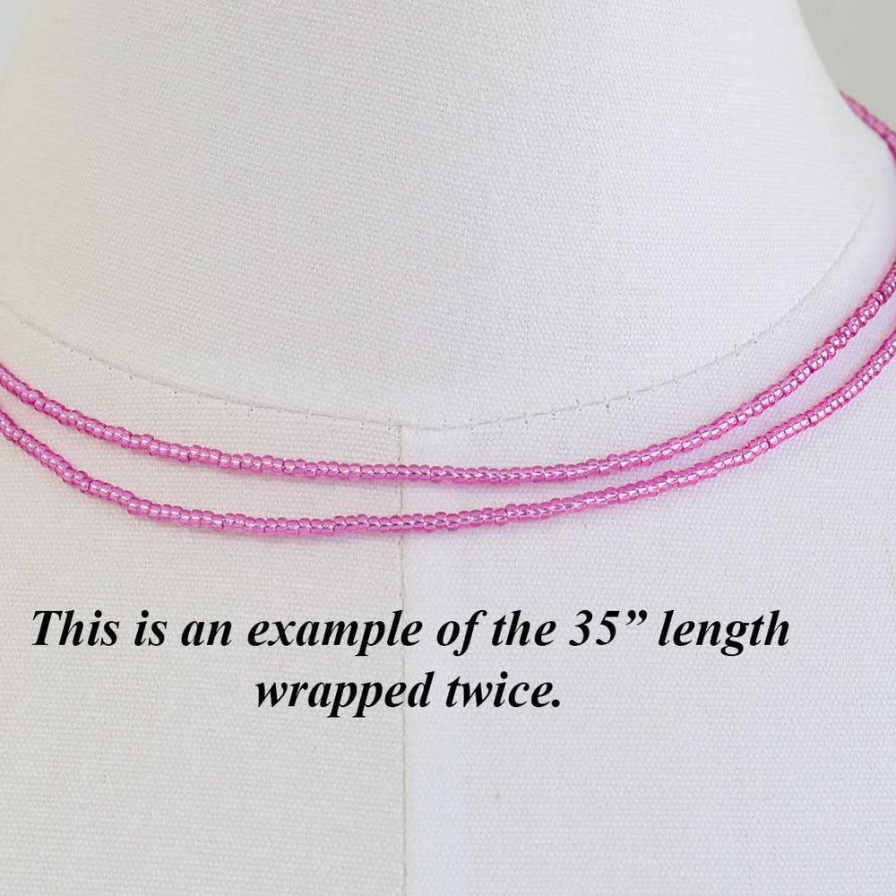
                      
                        Pink beaded necklace on a mannequin with text indicating length double wrapped 35" , on a white background
                      
                    