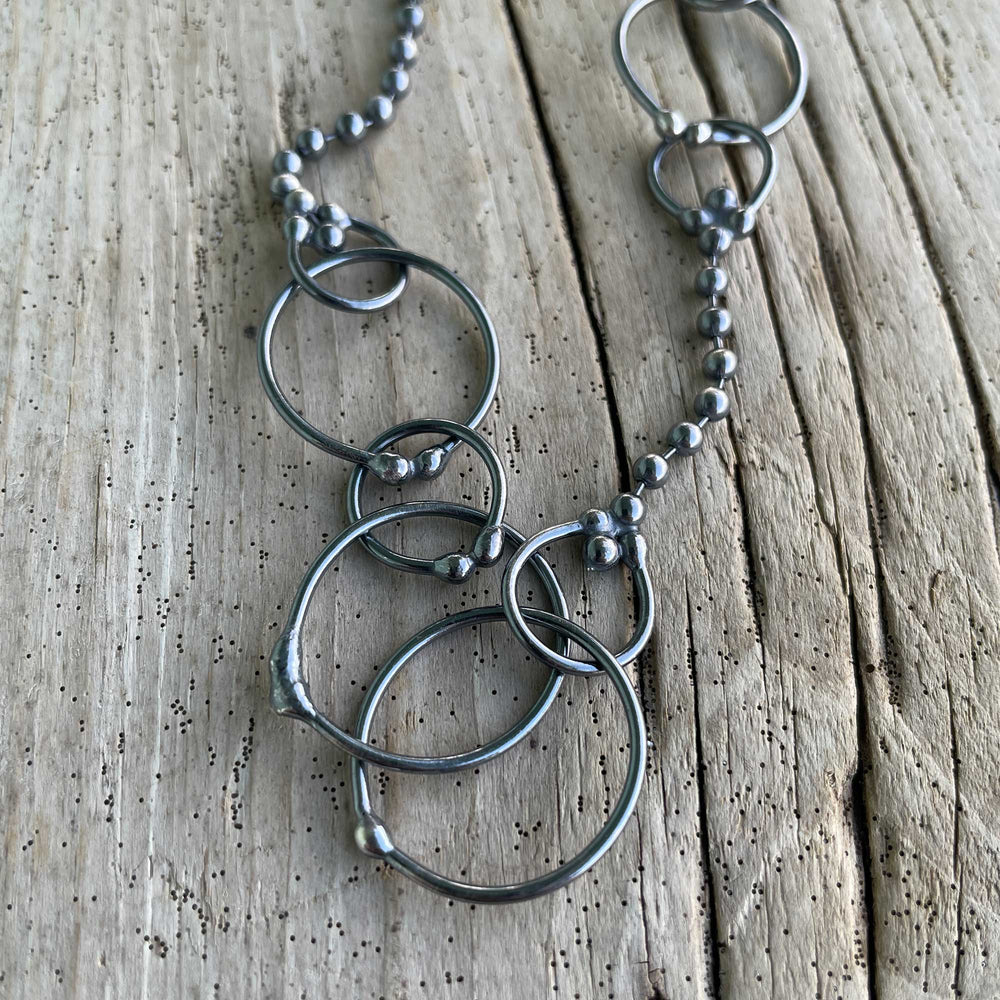 
                      
                        Silver necklace with interlocking rings 
                      
                    