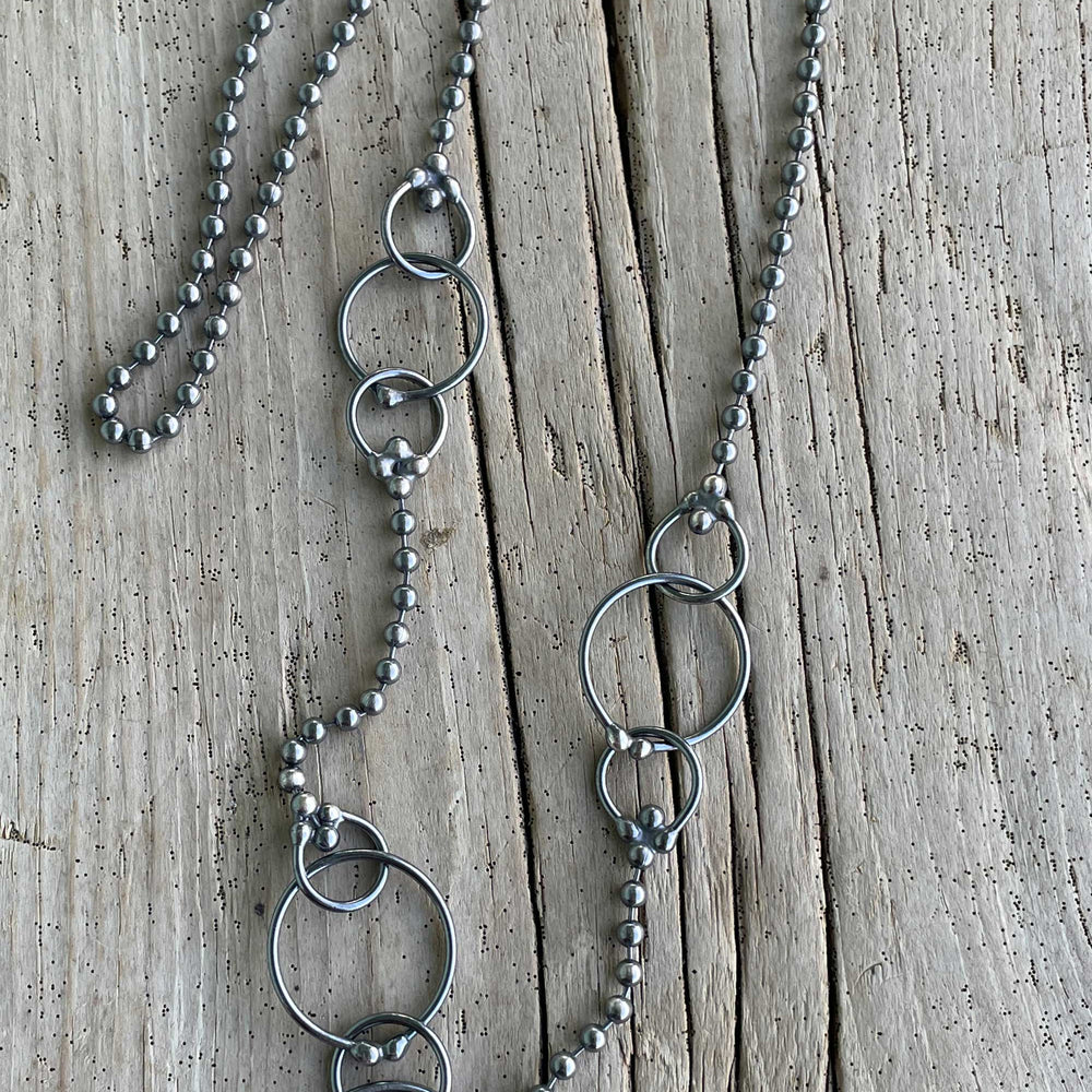 
                      
                        Silver necklace with circular pendants 
                      
                    