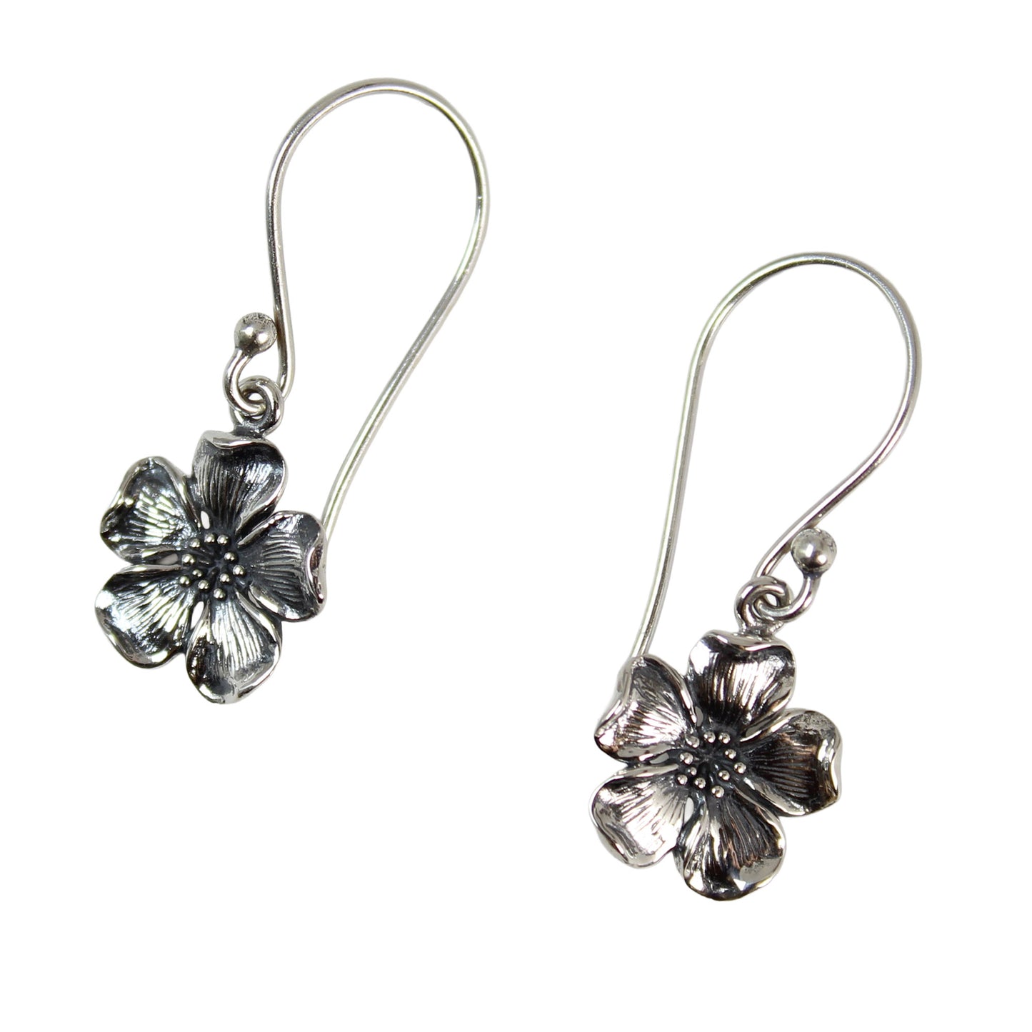 Overhead view of 925 sterling silver cherry blossom dangles showing the delicate floral texture.