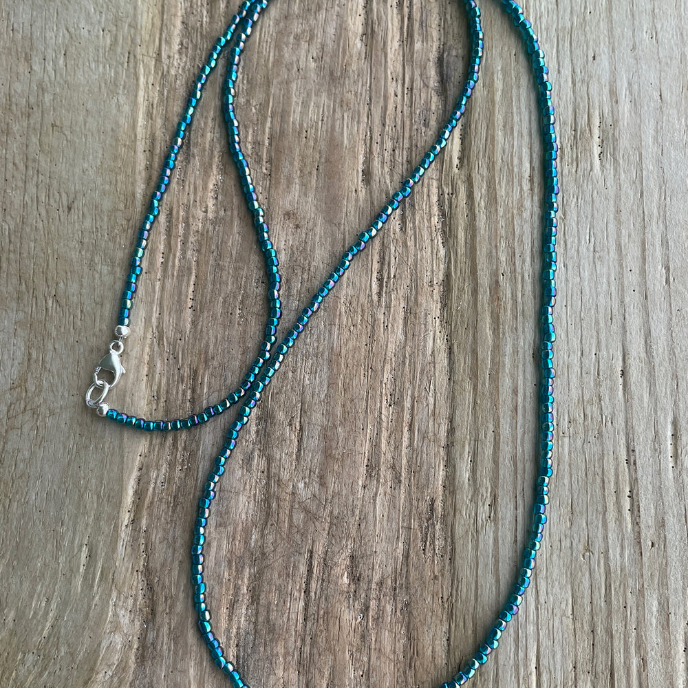 
                      
                        Transparent Rainbow Teal Seed Bead Necklace
                      
                    