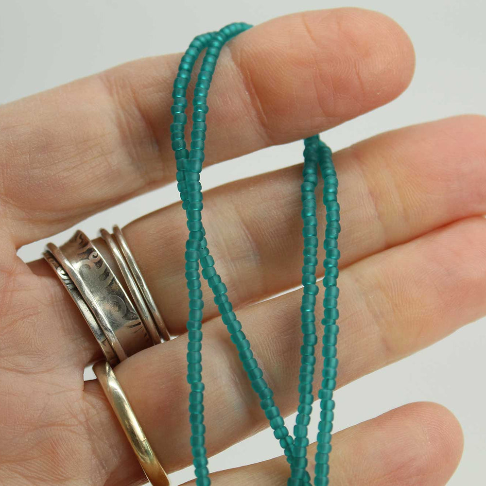 
                      
                        Transparent Teal Matte Seed Bead Necklace
                      
                    