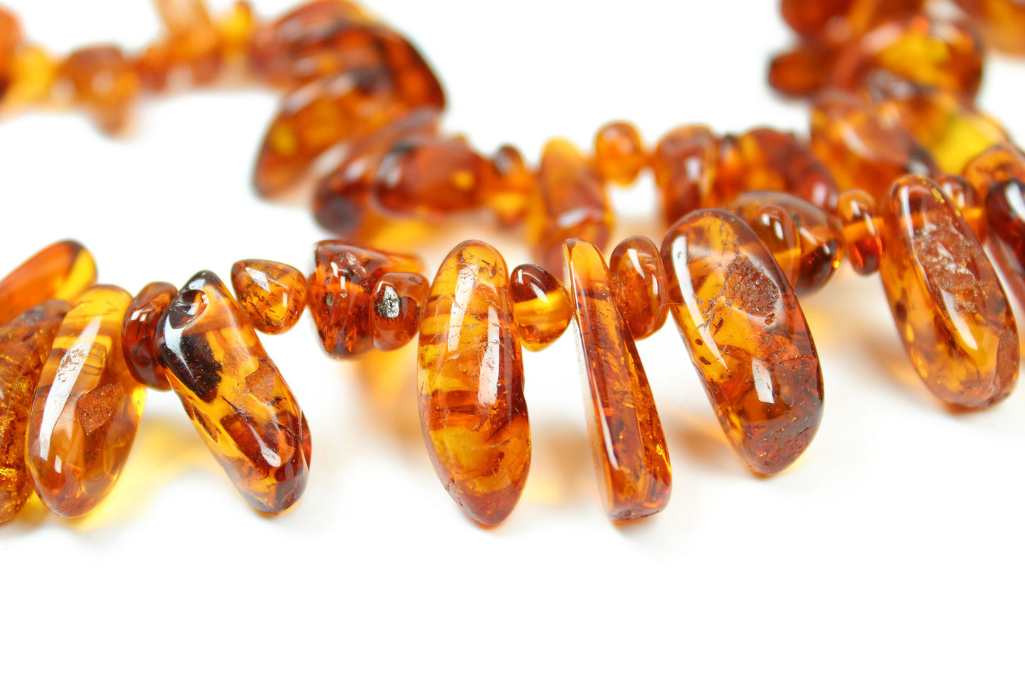 Close-up of amber beads on a white background