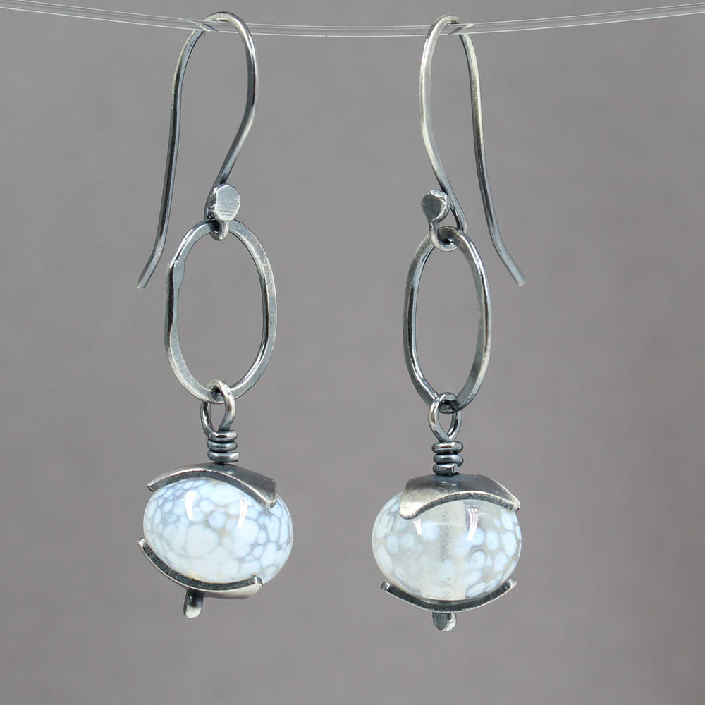 
                      
                        Silver earrings with white beads
                      
                    
