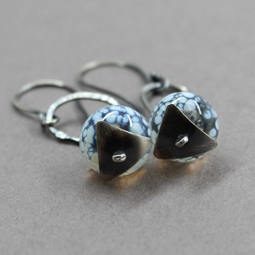 
                      
                        Pair of earrings with geometric bead caps
                      
                    