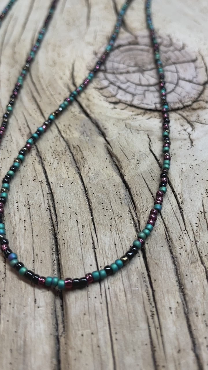 Load and play video in Gallery viewer, Mixed Teal Green Black and Plum Seed Bead Necklace
