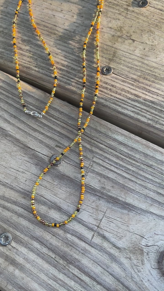 
                      
                        Load and play video in Gallery viewer, Mustard Black Gold Seed Bead Necklace
                      
                    