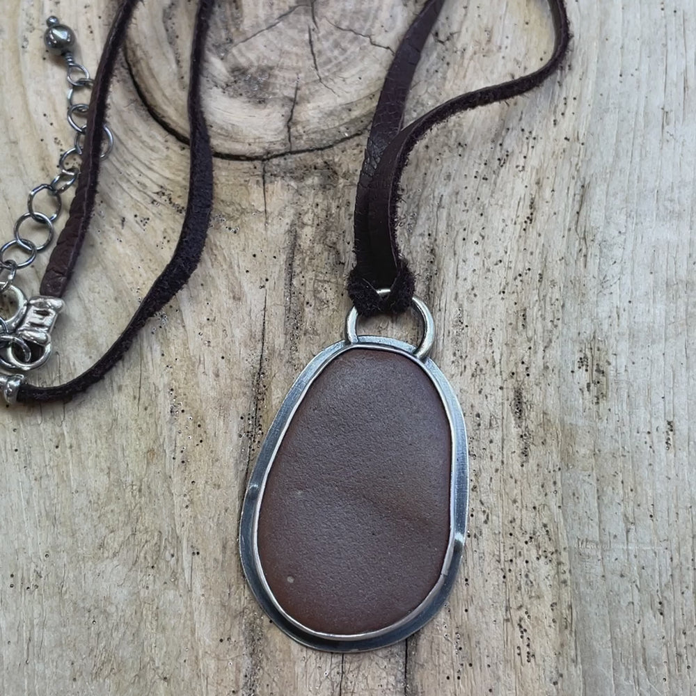 
                      
                        Load and play video in Gallery viewer, Brown Beach Stone Pendant in Sterling Silver with Deer Skin Lace
                      
                    