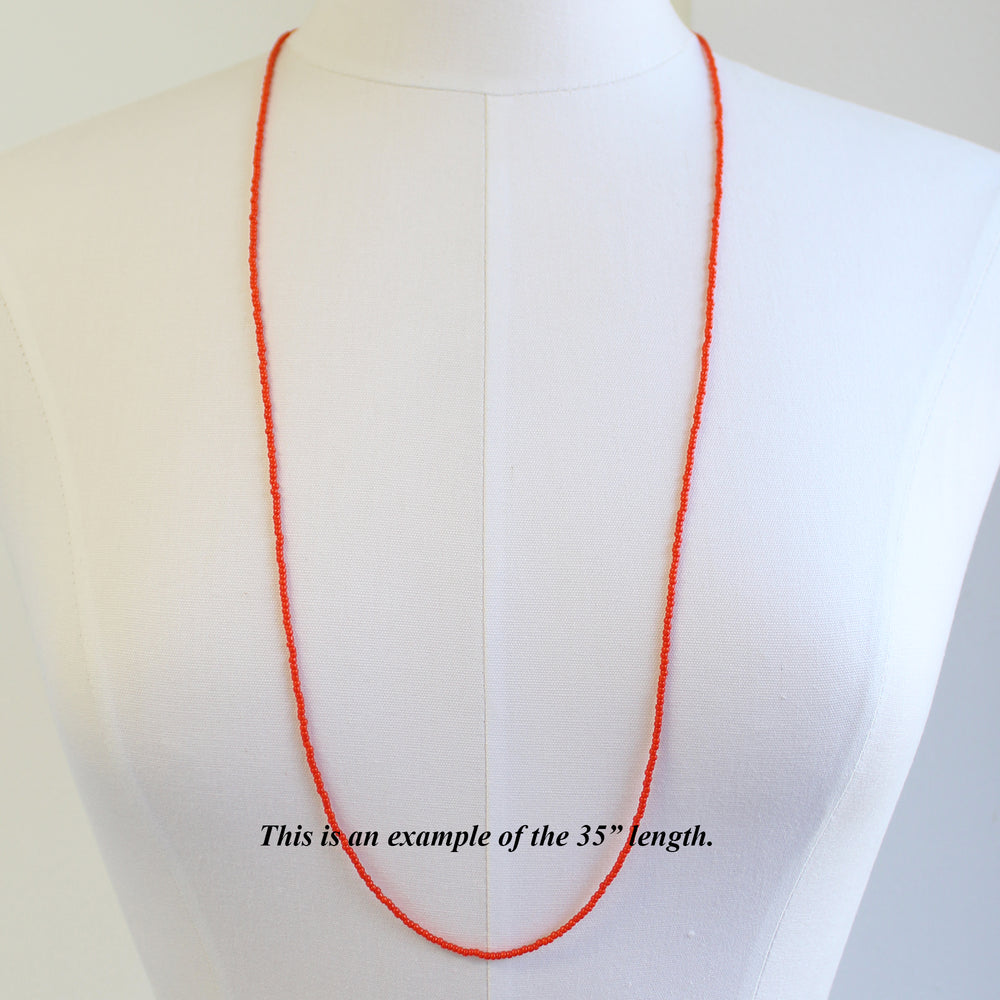 
                      
                        Sunset Orange Seed Bead Necklace, Thin 1.5mm Single Strand
                      
                    