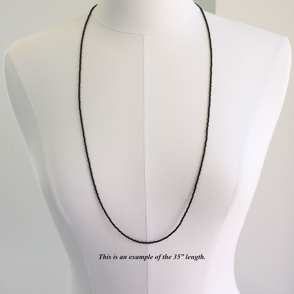 
                      
                        Long Black Seed Bead Necklace
                      
                    