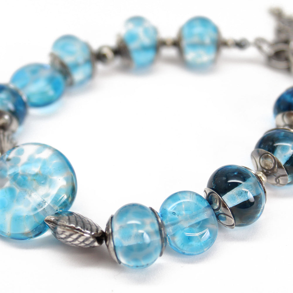 
                      
                        Blue Beaded Bracelet with Sterling Silver Shells
                      
                    