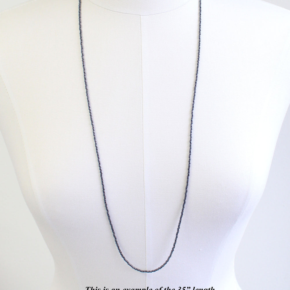 
                      
                        Hematite Glass Seed Bead Necklace
                      
                    