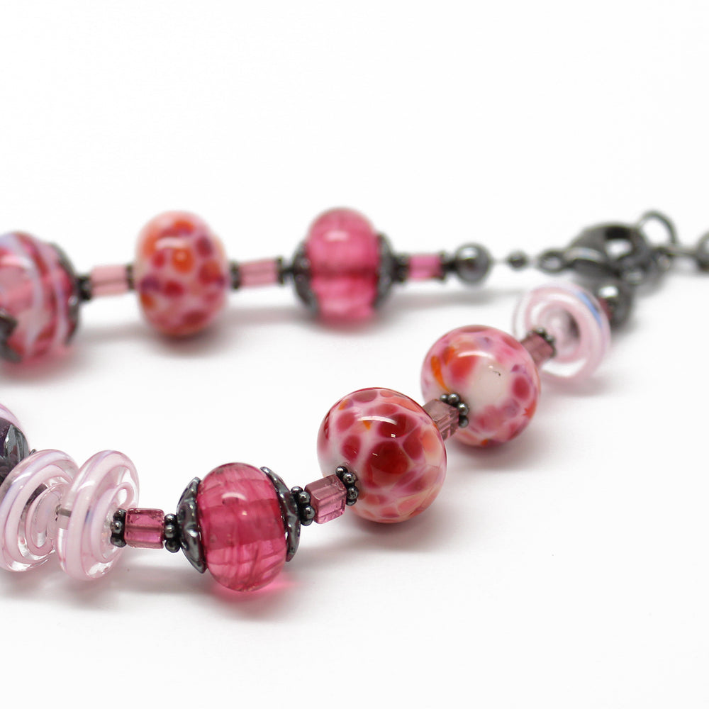 
                      
                        Pink Lampwork Bead Bracelet with Tourmaline 
                      
                    