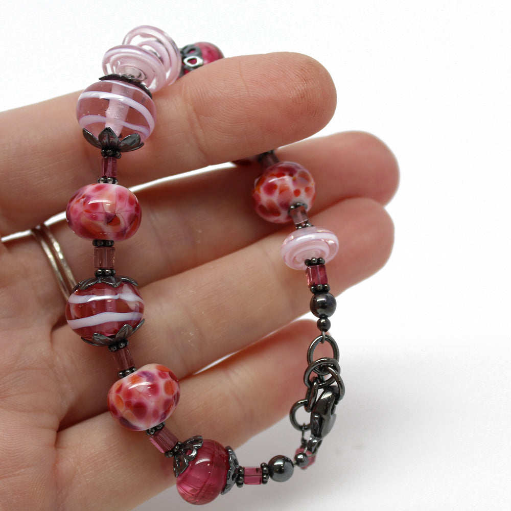 
                      
                        Handmade Pink Lampwork Bead Bracelet with Tourmaline 
                      
                    