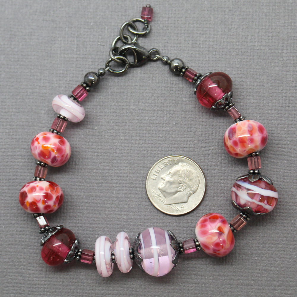 
                      
                        Pink Lampwork Bead Bracelet with Tourmaline 
                      
                    